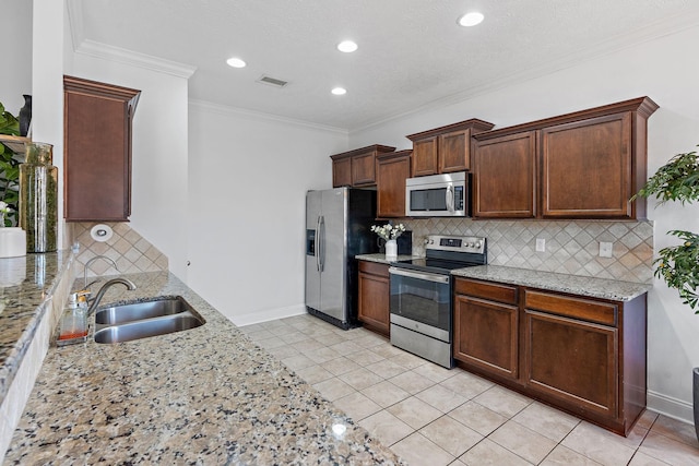 kitchen with light tile patterned floors, visible vents, stainless steel appliances, crown molding, and a sink