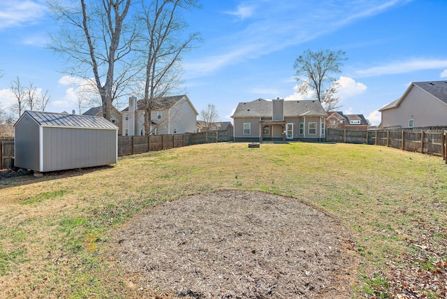 view of yard featuring a fenced backyard, an outdoor structure, and a shed