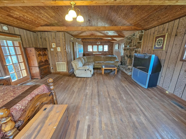 unfurnished living room with wooden walls, wooden ceiling, a notable chandelier, and hardwood / wood-style flooring