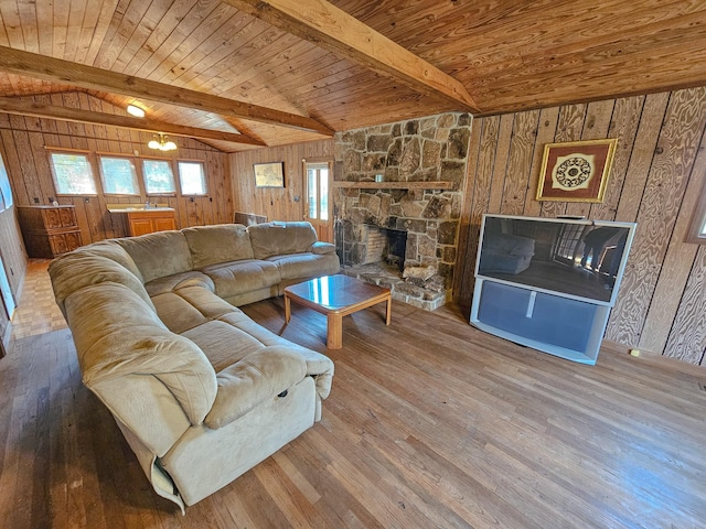 living room featuring hardwood / wood-style flooring, vaulted ceiling with beams, and wooden walls