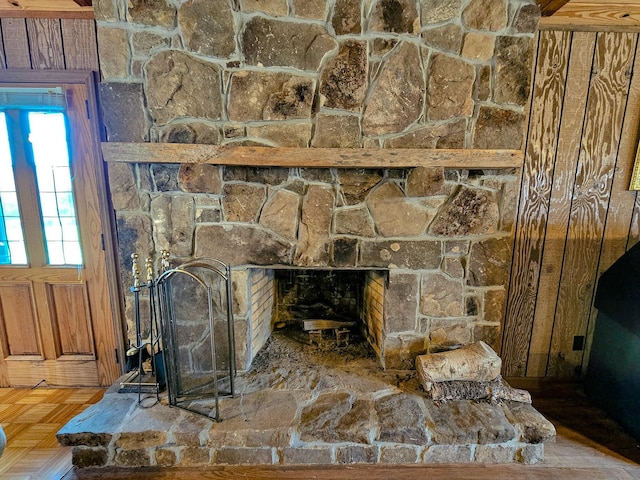 details featuring wooden walls, a fireplace, and parquet floors