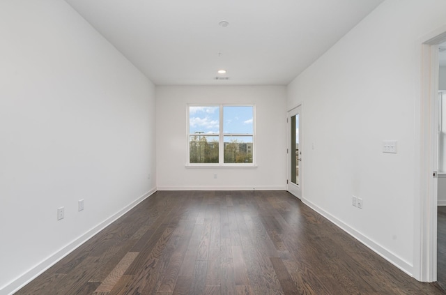 unfurnished room with dark wood-type flooring