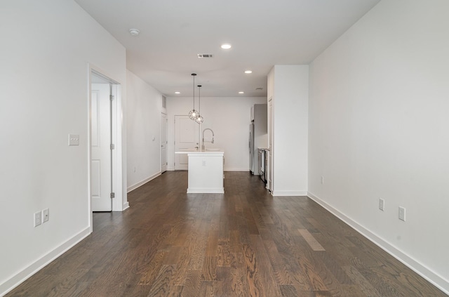 unfurnished living room with dark hardwood / wood-style floors and sink