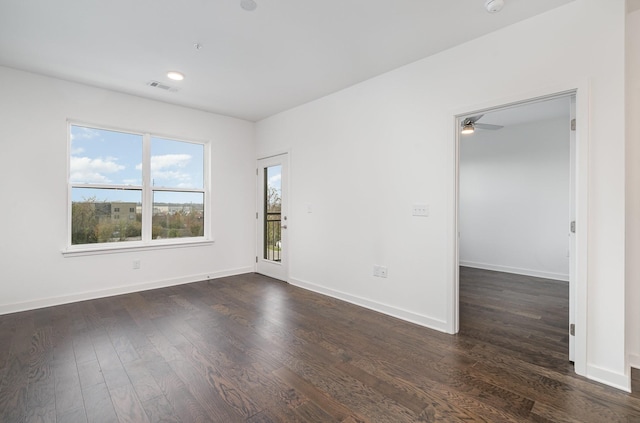 unfurnished room featuring ceiling fan and dark hardwood / wood-style flooring