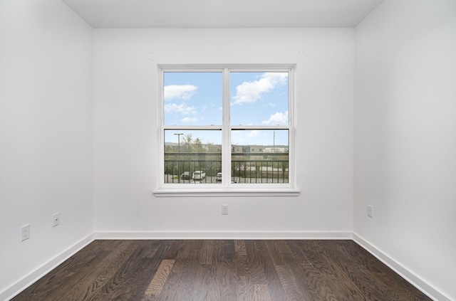 spare room with dark wood-type flooring