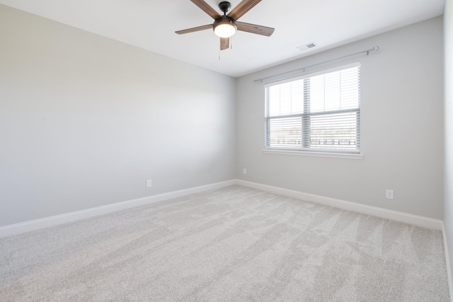 unfurnished room featuring light colored carpet and ceiling fan