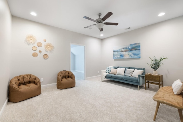 sitting room with light carpet and ceiling fan