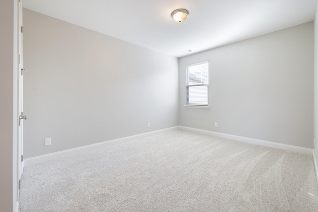 unfurnished room with light carpet