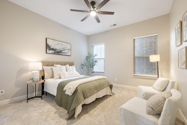 bedroom with ceiling fan and light colored carpet