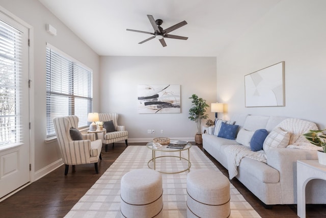 living room featuring a wealth of natural light, ceiling fan, and dark hardwood / wood-style floors