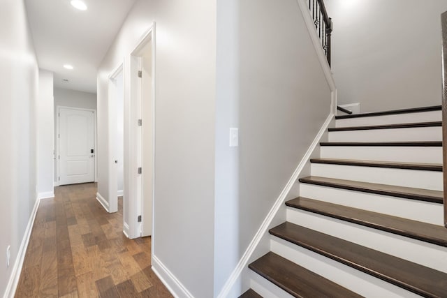 staircase with hardwood / wood-style floors