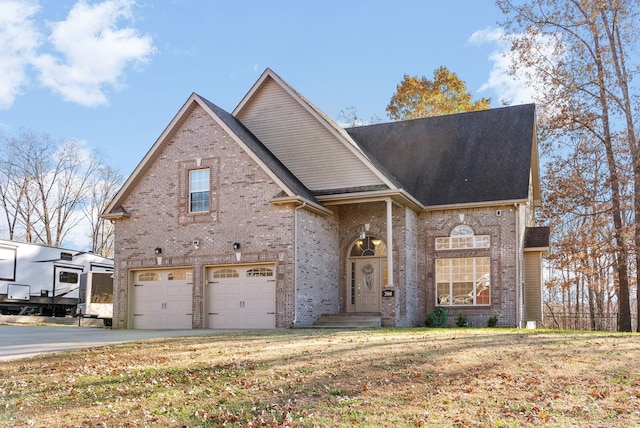 front of property with a garage and a front lawn