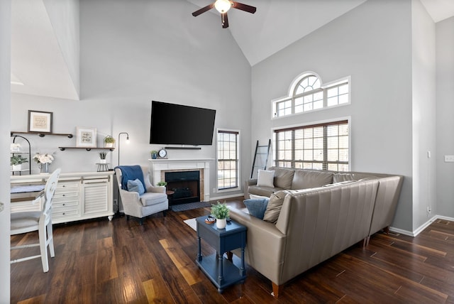 living room featuring dark hardwood / wood-style floors, ceiling fan, and high vaulted ceiling