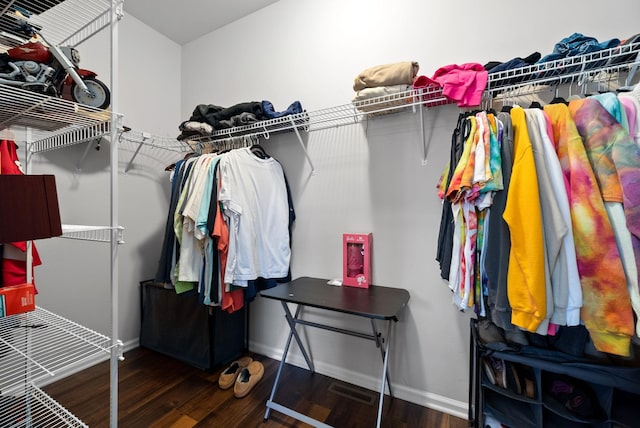 spacious closet featuring dark hardwood / wood-style flooring