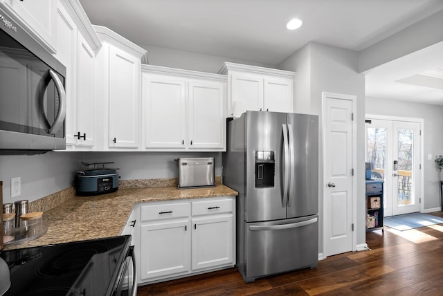 kitchen featuring white cabinets, dark wood-type flooring, appliances with stainless steel finishes, and french doors