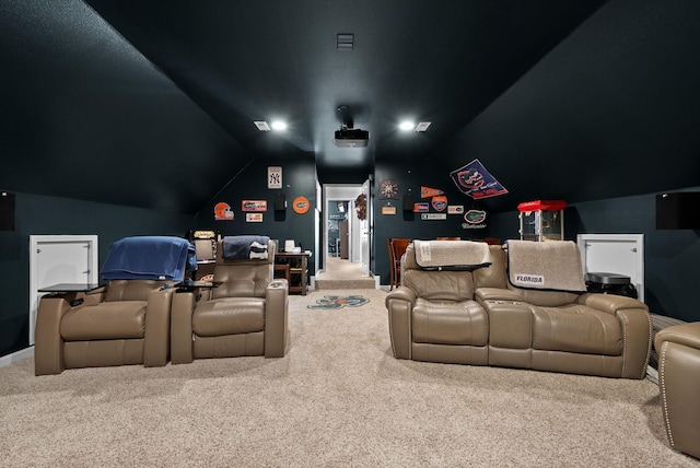 carpeted home theater room with lofted ceiling