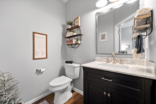 bathroom with hardwood / wood-style floors, vanity, and toilet