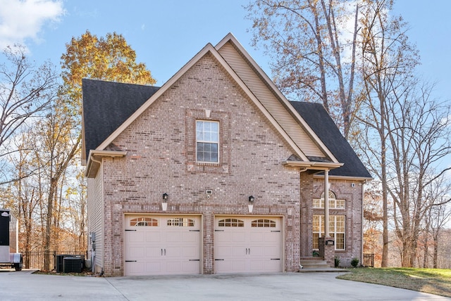 view of side of home with a garage and central air condition unit