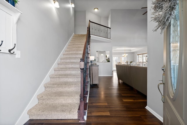 foyer entrance featuring a notable chandelier and dark hardwood / wood-style flooring