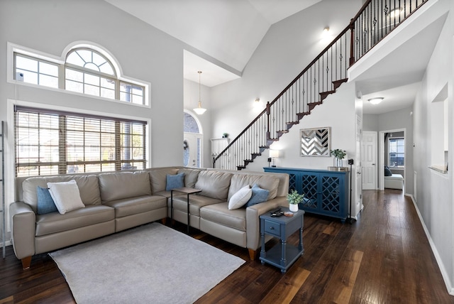 living room with dark hardwood / wood-style flooring and high vaulted ceiling