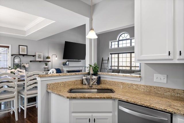 kitchen featuring pendant lighting, white cabinetry, dishwasher, and a healthy amount of sunlight