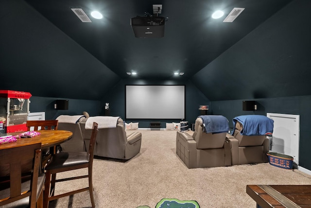 home theater room with carpet and vaulted ceiling