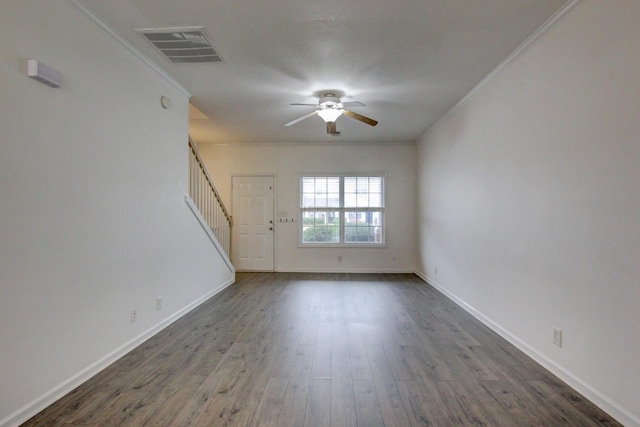 unfurnished room with crown molding, ceiling fan, and dark wood-type flooring