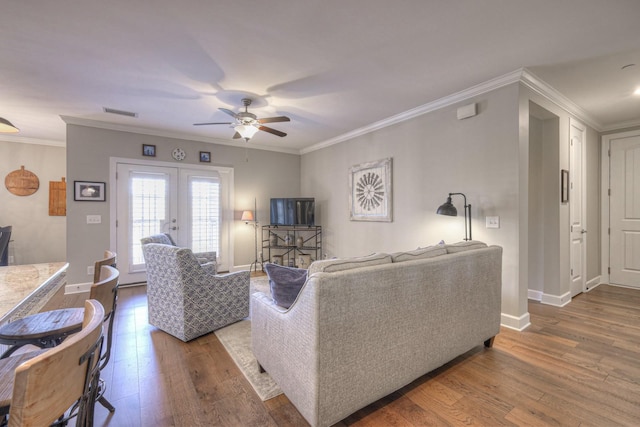 living room with wood-type flooring, french doors, crown molding, and ceiling fan