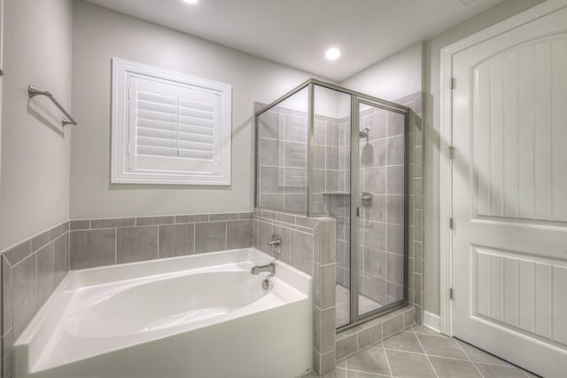 bathroom featuring tile patterned floors and separate shower and tub