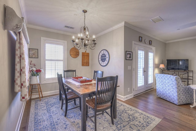 dining room with crown molding, hardwood / wood-style floors, and french doors