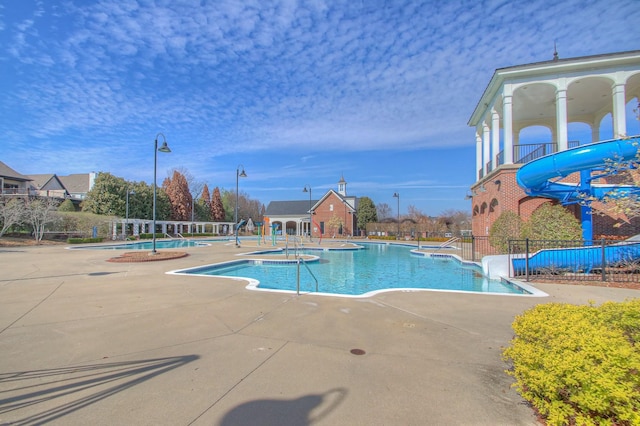 view of pool featuring a patio and a water slide