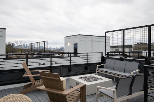 view of patio featuring an outdoor living space with a fire pit