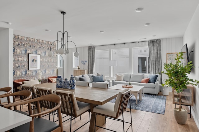 dining room featuring light hardwood / wood-style floors and a notable chandelier