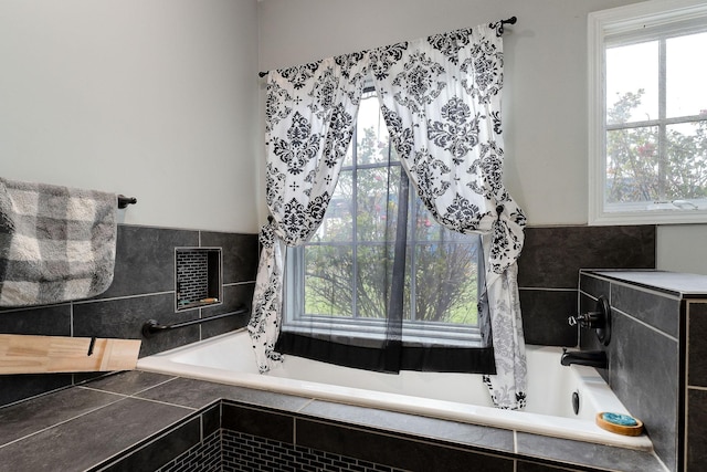 bathroom featuring plenty of natural light and a relaxing tiled tub