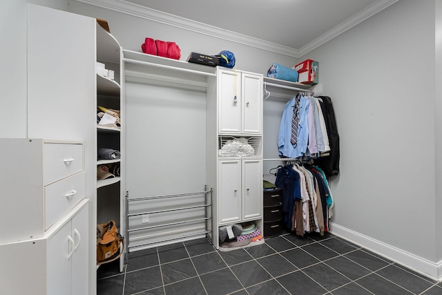 walk in closet featuring dark tile patterned floors