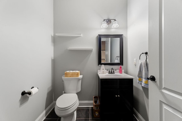 bathroom featuring tile patterned flooring, vanity, and toilet