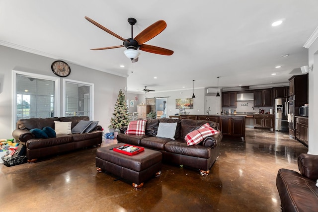 living room featuring ceiling fan and ornamental molding