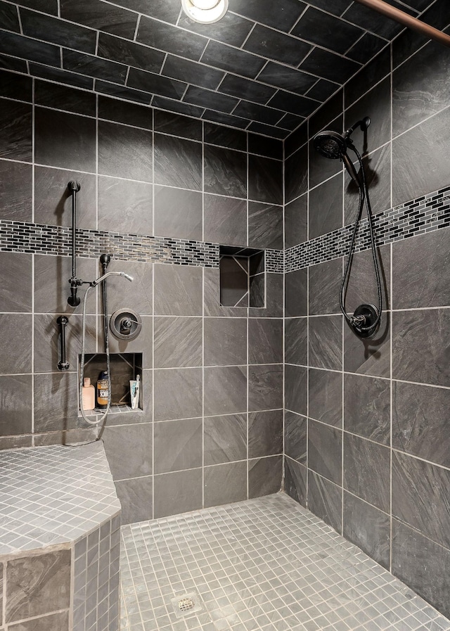 bathroom with a tile shower