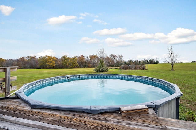 view of swimming pool with a lawn