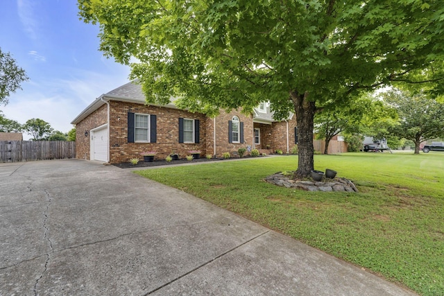 view of front of home featuring a front lawn and a garage