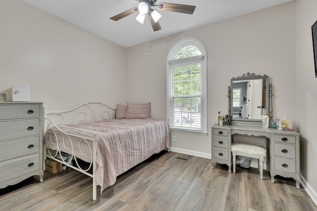 bedroom with ceiling fan and light hardwood / wood-style flooring