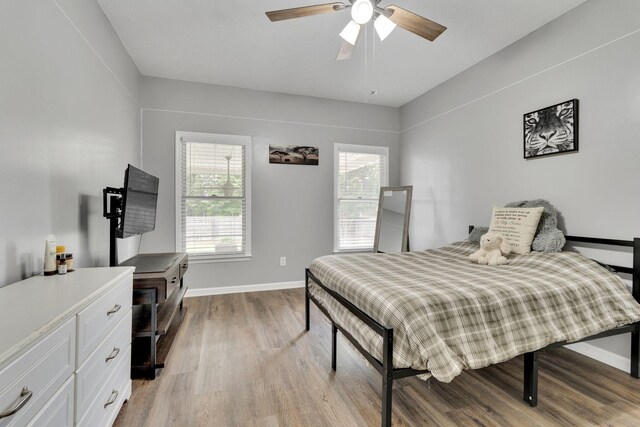 bedroom featuring hardwood / wood-style floors and ceiling fan