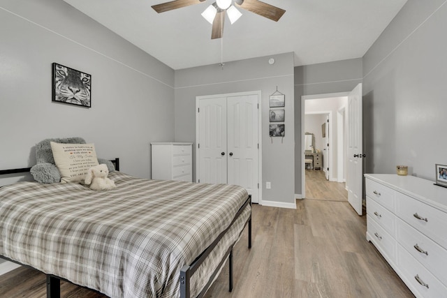 bedroom with ceiling fan, a closet, and light hardwood / wood-style flooring