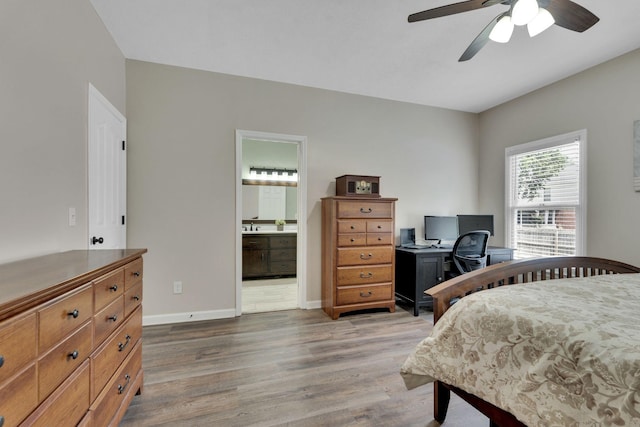 bedroom with wood-type flooring, connected bathroom, and ceiling fan