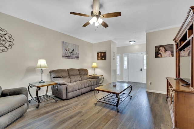 living room with dark hardwood / wood-style floors, ceiling fan, and ornamental molding