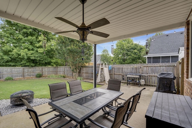 view of patio / terrace featuring ceiling fan and a fire pit