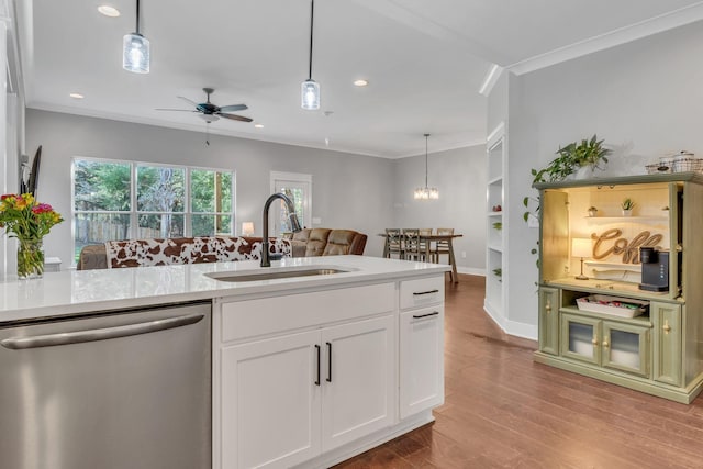 kitchen with pendant lighting, dishwasher, white cabinets, sink, and light wood-type flooring