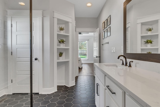 bathroom featuring tile patterned flooring, vanity, and built in shelves