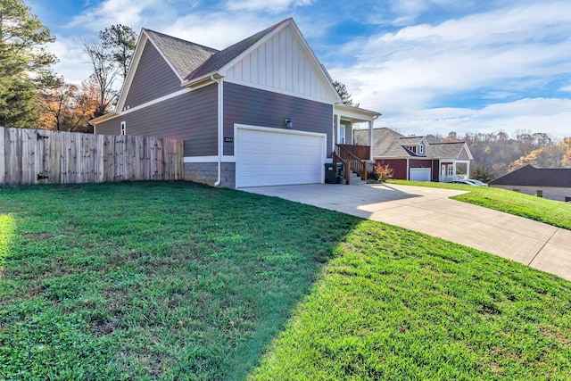 view of side of property featuring a yard and a garage