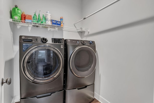 laundry room featuring washing machine and clothes dryer